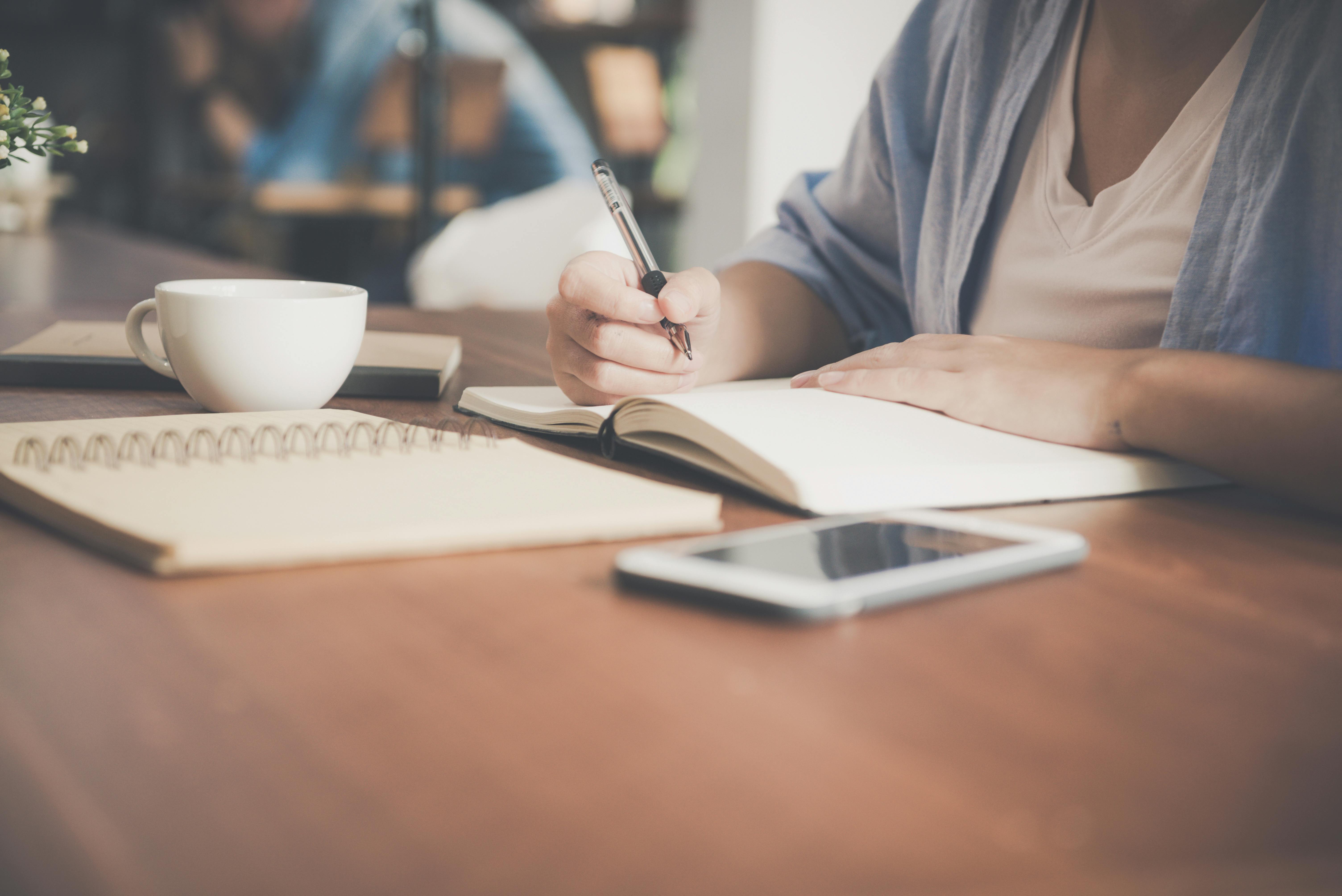 a person writing something in a book